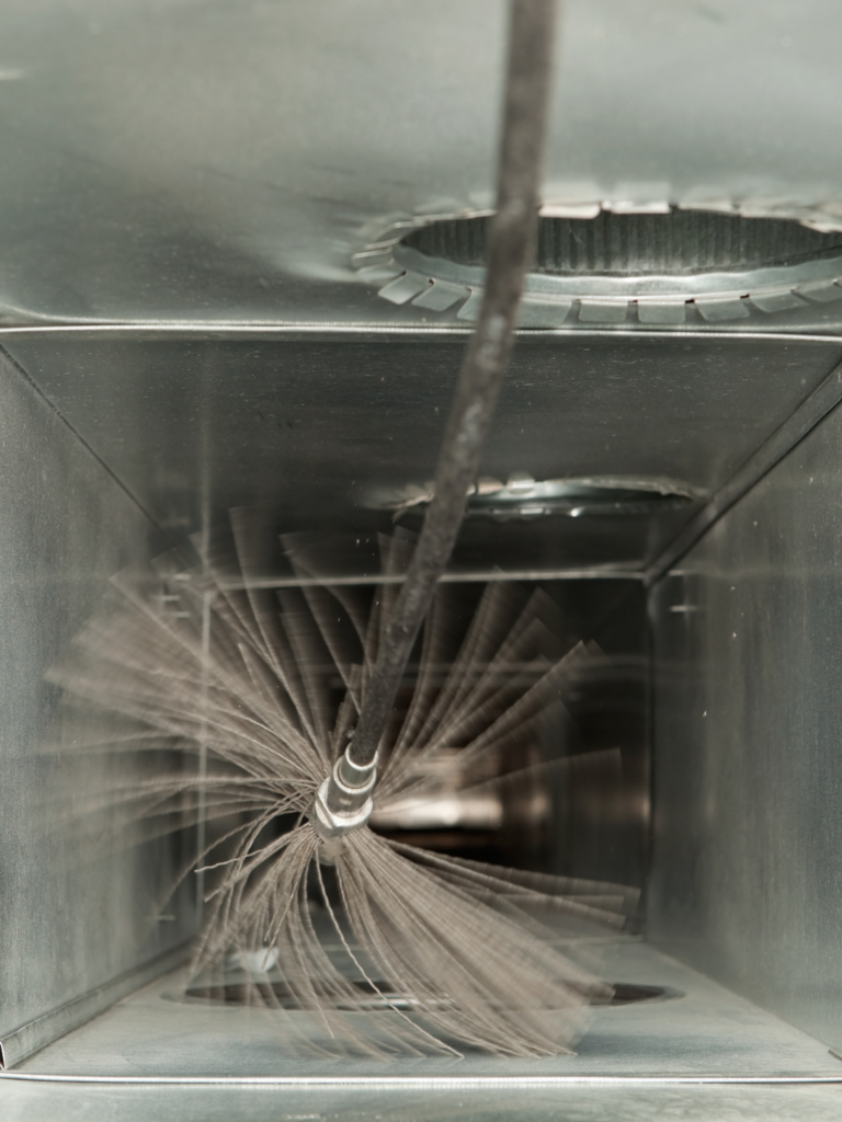 Interior view of a cleaning tool inside an air duct.