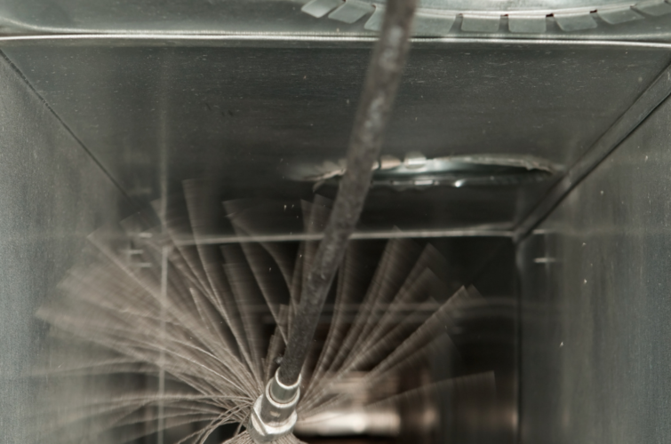 Interior view of a cleaning tool inside a commercial air duct.